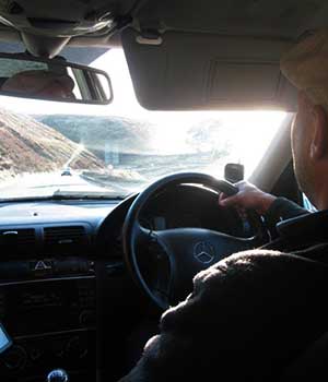 close up photo from inside a mercedes showing a sheffield airport taxis driver driving to manchester airport with stunning country side views through the window